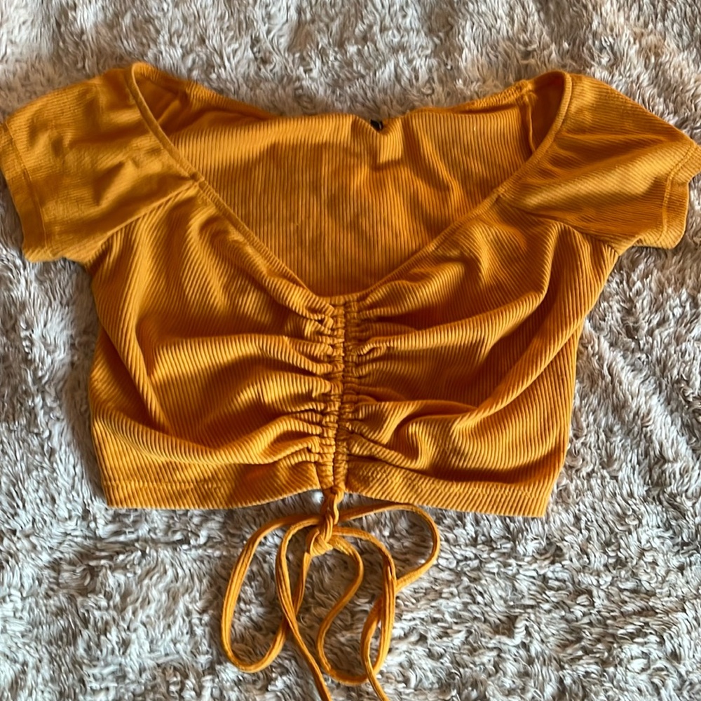 Orange/Yellow ribbed crop top with string to adjust length.
